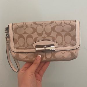Tan and cream coach wristlet